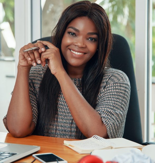 Content ethnic businesswoman at working desk Content ethnic businesswoman at working desk